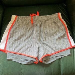 Athletic shorts with built in bike shorts. Never worn. Perfect condition!